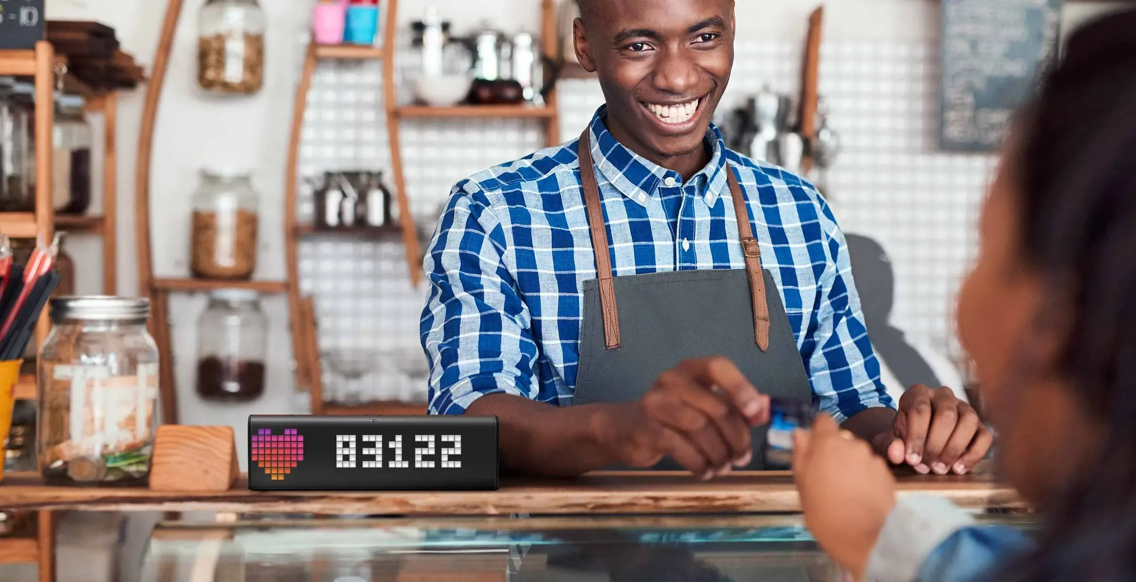 LaMetric Time smart clock, placed on a store counter, shows follower count for your Instagram account